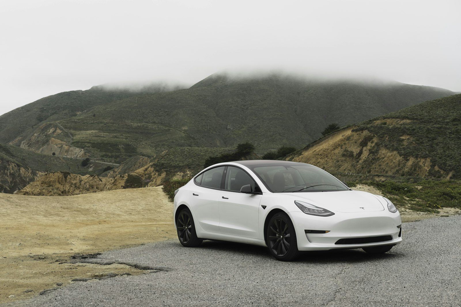 White sedan parked on a gravel overlook